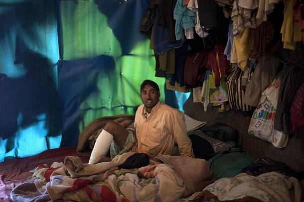 Bangladeshi worker Mohamed is seen inside his tent in Manolada on 18 April 2013, after foremen opened fire on him and other workers. Photo: Reuters 