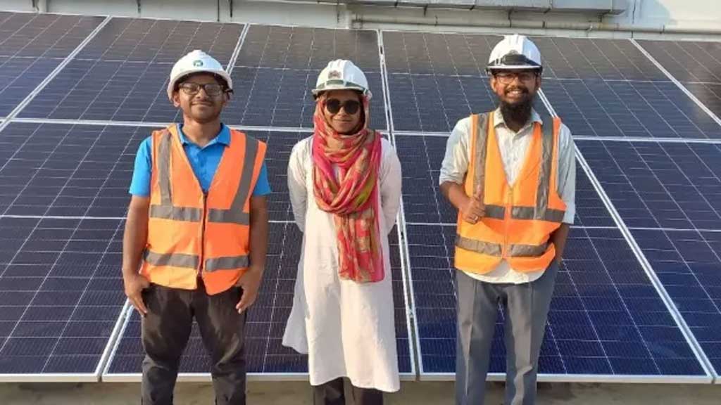 Farzana Akter Isha, a 24-year old engineer, poses before a rooftop solar plant along with her colleagues from SOLshare, Dhaka, Bangladesh, January 2024. Thomson Reuters Foundation 