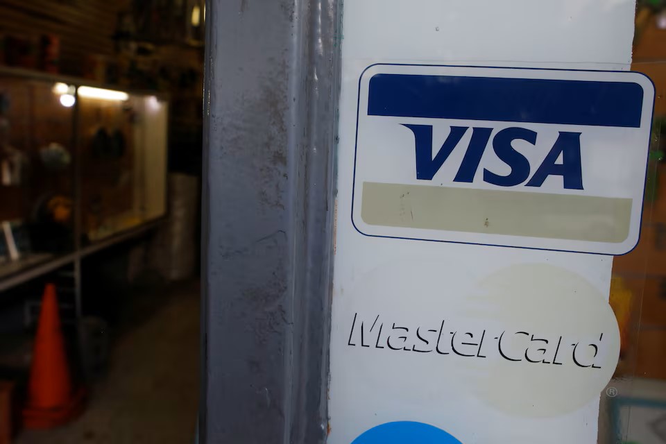  Stickers with the corporate logos of Visa and MasterCard are seen at the entrance of a hardware store in Caracas, Venezuela March 14, 2019.  REUTERS