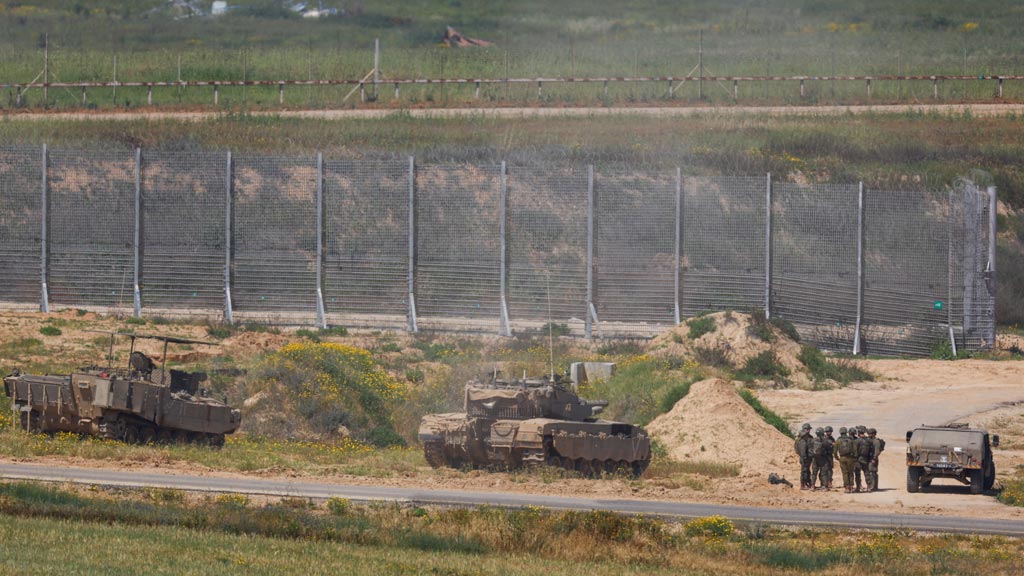 Caption-1:
Israeli soldiers stand near military vehicles, amid the ongoing conflict between Israel and the Palestinian Islamist group Hamas, near the Israel-Gaza border, as seen from Israel, April 4, 2024. REUTERS/Hannah McKay 