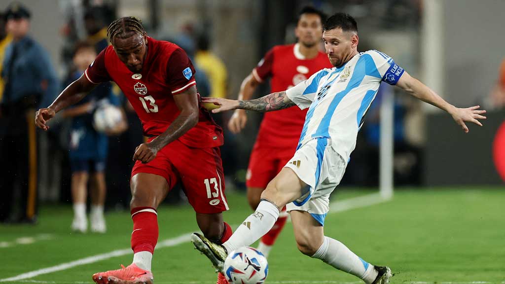 Copa America 2024 - Semi Final - Argentina v Canada - MetLife Stadium, East Rutherford, New Jersey, United States - Jul 9, 2024 Argentina's Lionel Messi in action with Canada's Derek Cornelius REUTERS/Agustin Marcarian