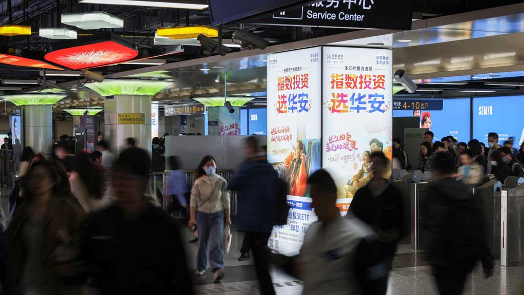 Commuters walk in a subway station at the Lujiazui financial district in Shanghai, China Apr 15, 2025. REUTERS/Go Nakamura