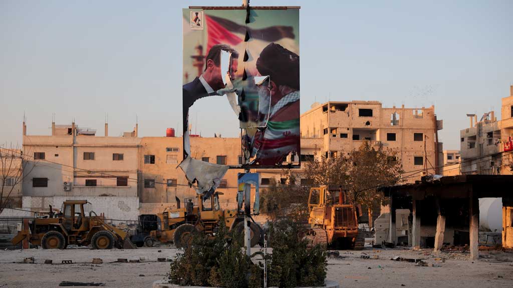 A torn poster showing former Syrian President Bashar al-Assad meeting with Iran's Supreme Leader Ayatollah Ali Khamenei, in the Sayyida Zaynab district in Damascus, Syria, December 14, 2024. REUTERS/Amr Alfiky